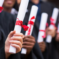 group of graduates holding their diploma