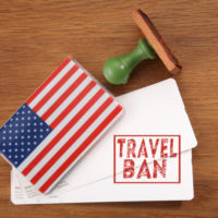 boarding pass with Travel Ban on it