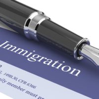 Immigration document with pen on top Immigration document with pen on top