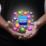 Social Media icons above hands