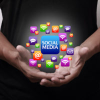 Social Media icons above hands