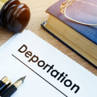 Deportation and other documents on a desk.