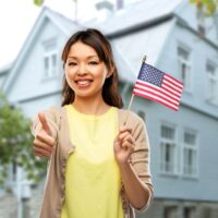 happy asian woman with american flag