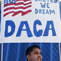 DACA sign above immigrant