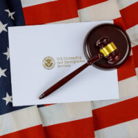 Judge's gavel, lawyers office deportation U.S. Citizenship and Immigration Services of naturalization with USA flag