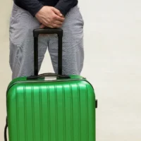 A man is waiting for deportation at the airport. Deporting of a foreign citizen. Voluntary departure and compulsory sending. Immigration and Emigration.Deport tourists.